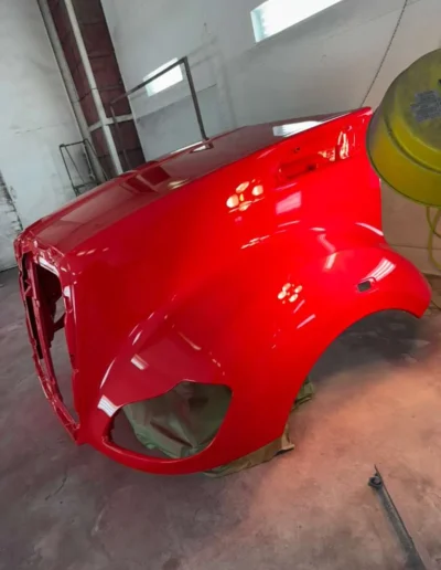 Large red cab section with extensive grey body filler and sanding work