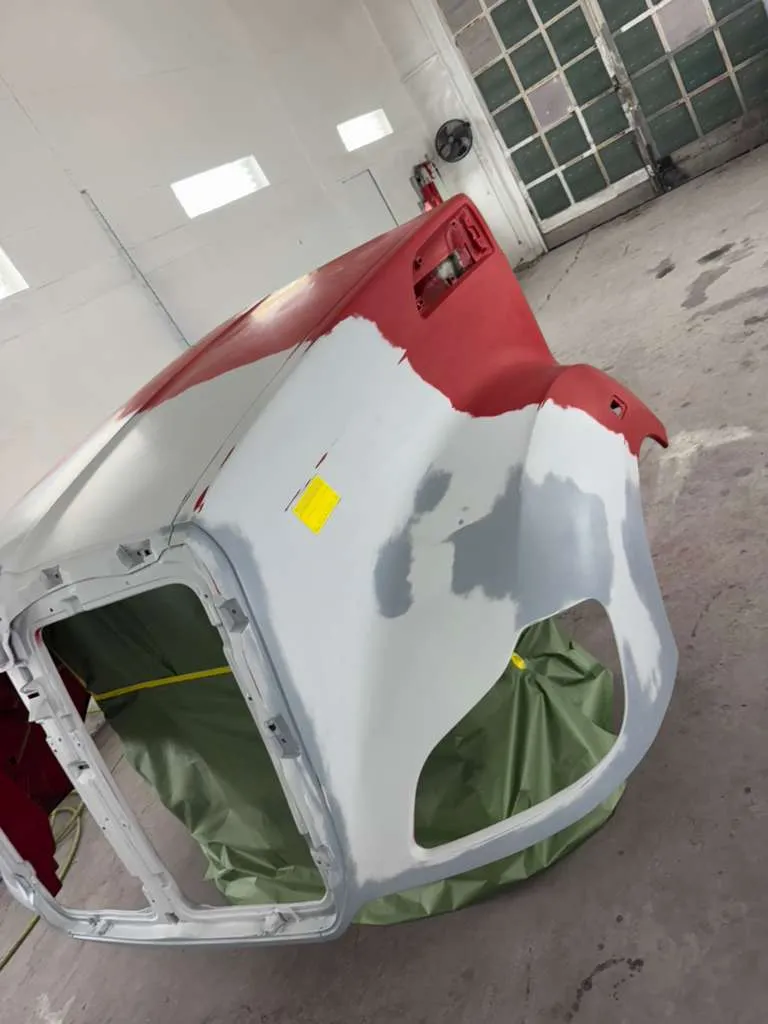 Truck hood with primer and body filler