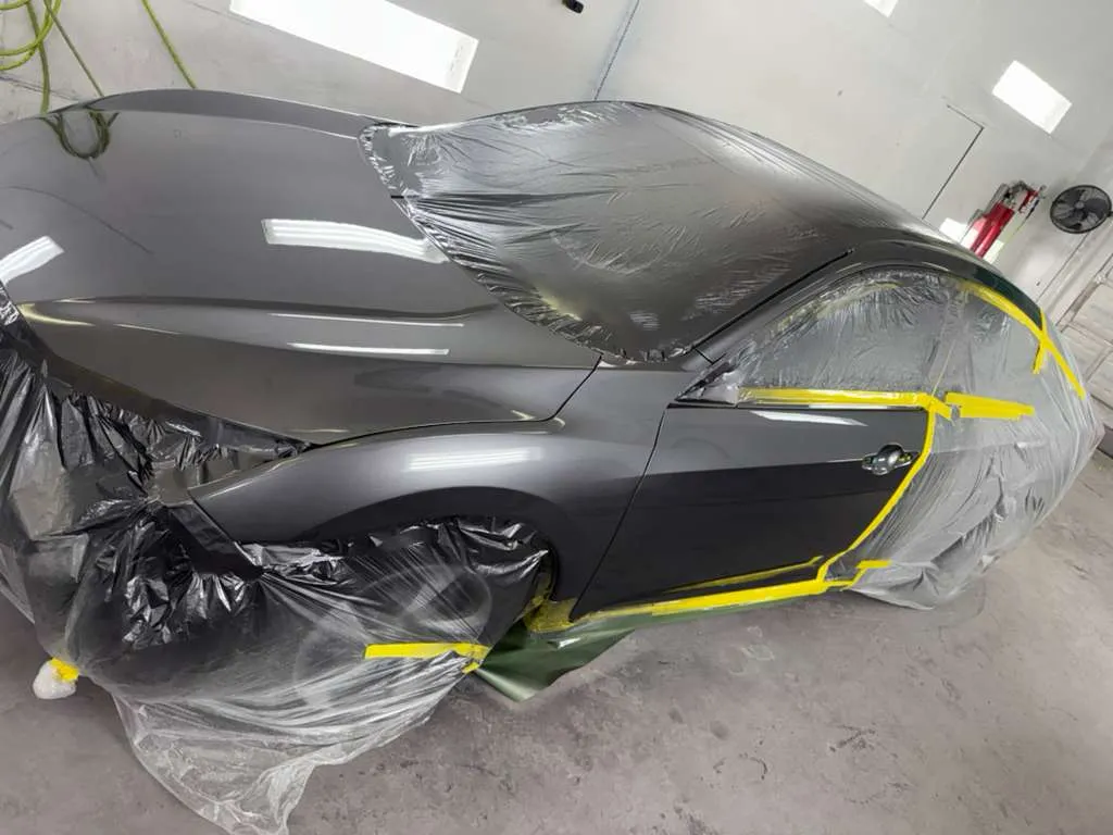 Professional car paint restoration in progress with a vehicle